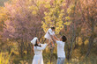 © saravut - Happy parents and kid walking together in summer