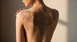 © Belv - Woman's back tattoo decorative and artistic depiction.