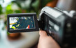 © Victoria - Hand with retro camcoder with LCD flip screen.