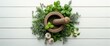 © VirtualVista - Variety of aromatic herbs, garlic, mortar and pestle arranged on white wooden surface, top view