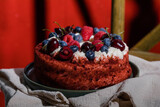 Moist red velvet cake with creamy frosting, a classic American dessert for celebrations.