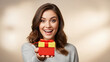 © Albert - Smiling woman holding a wrapped gift