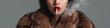 © Andrii Zastrozhnov - Asian woman smoking in fur coat with red lips