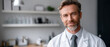 © perfectlab - Portrait of confident middle-aged male doctor in white coat smiling in modern medical with blurred background