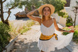 © mary_markevich - young attractive blond woman in summer style white dress and straw hat smiling having fun at the beach