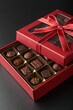 © Anastasiia Kasina - Red box of chocolate gift with ribbon isolated on black background