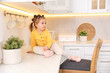 © New Africa - Child safety at home. Little girl sitting on counter in kitchen