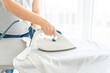 © Maria - Woman ironing white shirt on ironing board