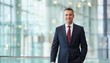 © Yka - Executive male walking in a modern glass-walled office