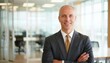 © Yka - Portrait of experienced senior businessman standing in modern office