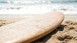 © Andrey - Wooden surfboard on sandy beach with ocean waves in background. Summer vacation and surfing lifestyle concept. Outdoor sport activity backdrop.