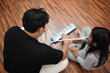 © airdone - Asian father teaching his young daughter how to play the melodica and recorder at home