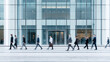 © Broccolini - blurred motion of business people walking in front of a modern glass office building facade, professional urban lifestyle and corporate architecture concept in a bright metropolitan setting.