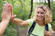 © auremar - female hiker making high-five with companion