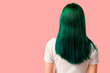© Pixel-Shot - Young woman with green hair on pink background, back view