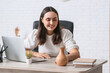 © Pixel-Shot - Beautiful young woman with modern laptop and air humidifier on her workspace in office