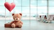 © keks20034 - A cute teddy bear holding a heart-shaped balloon next to a yellow suitcase in an airport setting