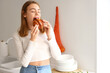 © Pixel-Shot - Beautiful young woman eating tasty croissant in kitchen