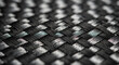 © Nabil - Detailed macro shot of a black and gray woven texture, highlighting the intricate braided pattern and fibrous material structure.