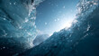 © Strother - Cinematic low angle view inside a blue glacial crevasse where bright sunlight illuminates flying ice crystals and translucent frozen walls.