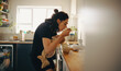 © Jacob Lund - Mother feeds baby at the kitchen counter