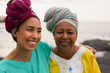 © Sabrina - Happy african mother and daughter having tender moment on the beach - Culture, traditional clothes and family lifestyle concept