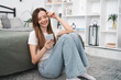 © InsideCreativeHouse - Smile, woman and relax with phone for social media browsing, reading e-book or research. Weekend, person and smartphone in living bed room for app download, online shopping and dating site in home