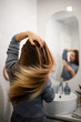 © Zoran Jesic - Woman tossing long hair reflecting in mirror
