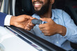 © Prostock-studio - Car Renting Service. Black Male Driver Taking Keys From Manager While Sitting In Rental Auto, Unrecognizable Smiling African American Man Enjoying Vehicle Leasing, Cropped Image, Closeup