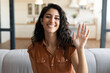 © Prostock-studio - Online communication, video chat and conferencing, internet meeting concept. Cheerful young woman calling her friend on webcam, talking to family remotely from home, waving at camera