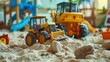© Global Stock - A photo of a sandbox with toy construction vehicles.