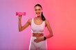 © Home-stock - Happy fit woman holding energy protein bar and put hand on belly, having snack after workout, posing over gradient neon background and smiling at camera