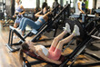 © JackF - Athletic woman doing leg press in the machine. Young woman wants to build muscle, she goes to the gym and does strength training.