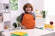 © New Africa - Boy packing his backpack for school at desk indoors