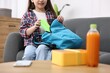 © New Africa - Girl packing her backpack for school on sofa at home, closeup