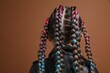 © New Africa - Cute girl with stylish braids on brown background, back view