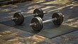 © Muhammad - A photo of a set of dumbbells on gym mats.