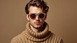 © IgorImageDoc - portrait young man wearing beige turtleneck sweater has serious expression his face looking directly camera his hair styled loose curls wearing pair round sunglasses gold frame background plain beige
