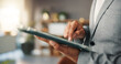 © peopleimages.com - Business person, hands and trading with tablet in office for investment or stock market research. Closeup, trader or investor scrolling with technology for online finance app or asset management