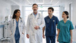 © Nataliya - Diverse medical team walking confidently in a hospital corridor. Group of doctors and nurses in scrubs and lab coats moving forward