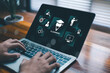 © wanchai peatoo - E-learning concept with laptop screen showing online education icons, digital training, business learning, skill development and knowledge growth, modern workspace and technology background.
