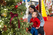 © leungchopan - Mother and baby son looking at christmas tree