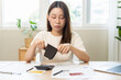 © KMPZZZ - Debt financial concept, stressed problem asian woman hand open empty wallet, purse not have budget of money to pay no have credit card, not able payment bill, loan or expense with bank, bankruptcy.