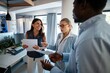 © Zoran Jesic - Team of diverse business professionals collaborating in modern office space
