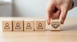 © ABDOU BERRI - Business partnership concept. Hand placing trust icon wooden block among people symbols, representing strategic collaboration trust and relationship building.