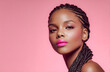 © Surachetsh - A stylish African woman showcases trendy braided hair and vivid makeup against colorful studio backdrops with a strong editorial fashion mood.