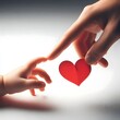 © Hajar - Close-up of adult and child hands sharing a red heart, symbolizing emotional connection, care, and intergenerational love.