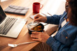 © Jelena - Person taking and eating delicious takeaway lunch at the desk