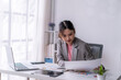 © Wasana - Asian businesswoman working with financial documents at office desk