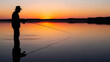 © Ropek - Silhouette of a man fishing at sunset on a calm lake.